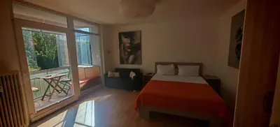 a bedroom with a bed and a large window at Cozy little nest, Bled region in Jesenice