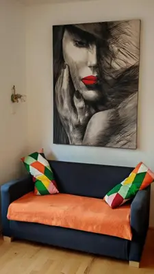 a painting of a woman sitting on a couch at Cozy little nest, Bled region in Jesenice