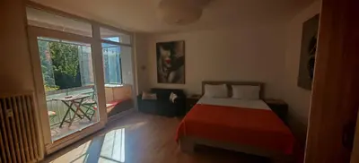 a bedroom with a bed and a large window at Cozy little nest, Bled region in Jesenice