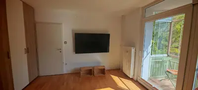 a room with a large window and a flat screen tv at Cozy little nest, Bled region in Jesenice