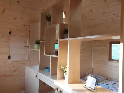 a room with wooden walls and a room with a desk at Lahinja & Kolpa river apartments in Metlika