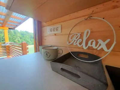 a kitchen with a table with a coffee mug on it at Lahinja & Kolpa river apartments in Metlika