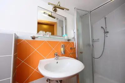 a bathroom with a sink and a shower at Sobe Grabar in Ptuj