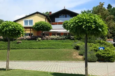two palm trees in front of a house at Sobe Grabar in Ptuj