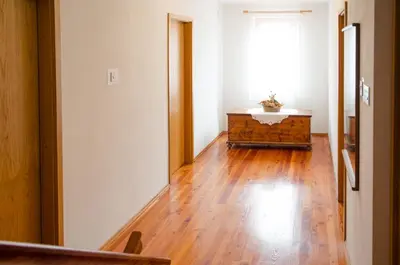 an empty room with a wooden floor and a window at Apartment pri Damijanu in Ponikve