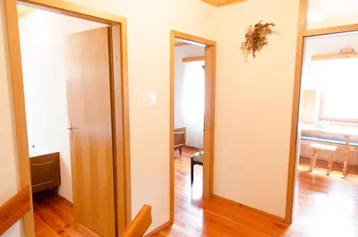 an empty room with a mirror and a hallway at Apartment pri Damijanu in Ponikve