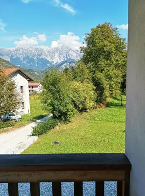 a view of the mountains from a balcony at ecoHouse FURLAN - Apartment PINJA in Kobarid