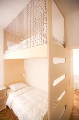 a bedroom with a bunk bed with a ladder at Isabella Living in Maribor