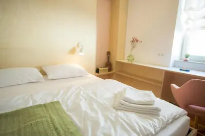 a hotel room with a bed with towels on it at Isabella Living in Maribor