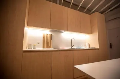 a kitchen with a sink and a light on the cabinets at Isabella Living in Maribor
