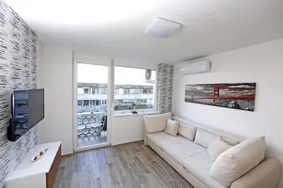 a living room with a couch and a tv at Studio Optim in Ljubljana