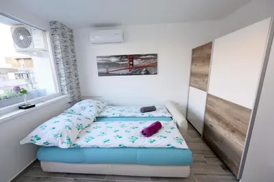 a small bedroom with a bed and a window at Studio Optim in Ljubljana