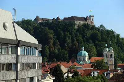 a view of a town with buildings and a mountain at Studio Optim in Ljubljana
