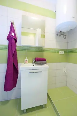 a bathroom with a sink and a mirror at Studio Optim in Ljubljana