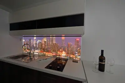 a kitchen with a window with a view of a city at Studio Optim in Ljubljana