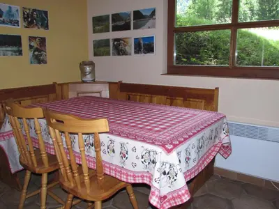 a dining room table with a red and white table cloth at Apartma Narnia in Bovec
