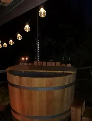 a barrel with lights on top of it at night at Slabnik Nature Escape in Idrija