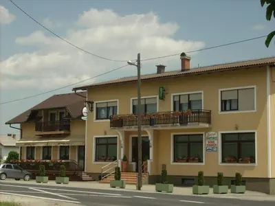 a building with two balconies on a street at Penzion Gostisce Lesjak in Orehova vas