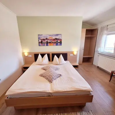a bedroom with a large bed in a room at Penzion Gostisce Lesjak in Orehova vas