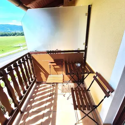 a balcony with two chairs and a table at Penzion Gostisce Lesjak in Orehova vas