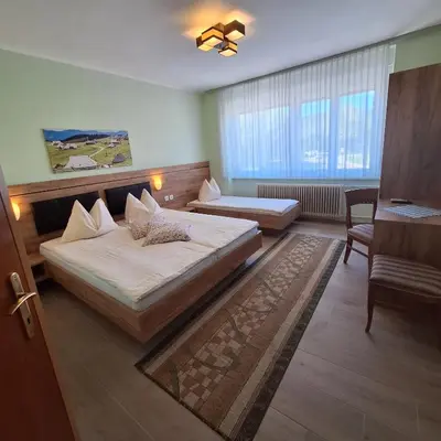 a hotel room with two beds and a window at Penzion Gostisce Lesjak in Orehova vas