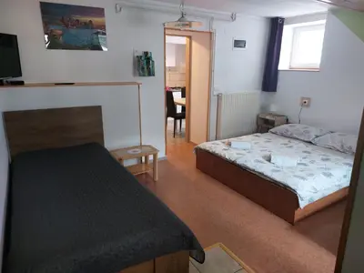 a small bedroom with a bed and a table at Apartment Carli-Jurč in Kobarid