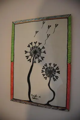 a mirror with a picture of two dandelions at Apartment with Free Parking in Ljubljana