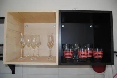 a shelf with wine glasses and cups on it at Apartment with Free Parking in Ljubljana