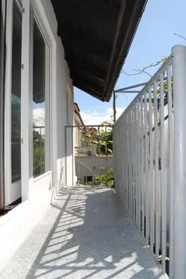 a balcony of a house with a white fence at Apartment with Free Parking in Ljubljana