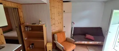 a small room with a chair and a bed at Apartma NADIŽA in Borjana