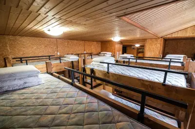 a room with a bunch of beds in it at Hostel Paradiso in Tolmin