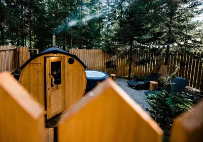 a small wooden dog house in a backyard at Glamping FOREST EDGE in Kamnik