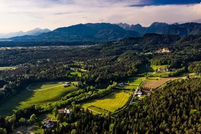 an aerial view of a valley with mountains at Glamping FOREST EDGE in Kamnik