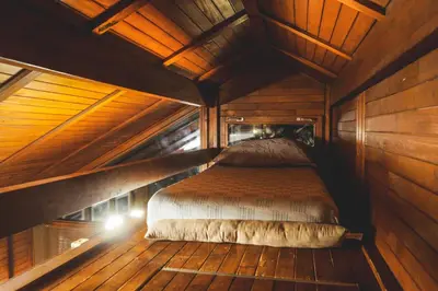 a bedroom with a bed in a wooden cabin at Lucky home in Čatež ob Savi