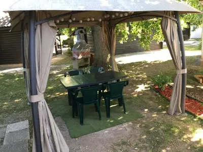 a gazebo with a table and chairs under it at Lucky home in Čatež ob Savi