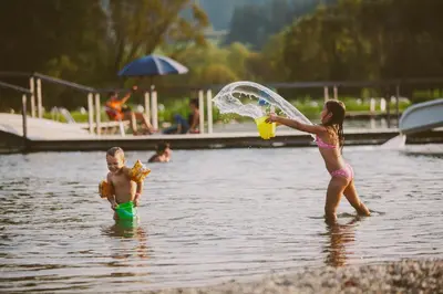 a boy and a girl playing in the water at Hotel & Hostel Marenberg Radlje in Radlje ob Dravi