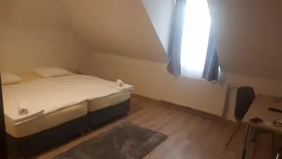 a small bedroom with a bed and a window at Hotel & Hostel Marenberg Radlje in Radlje ob Dravi