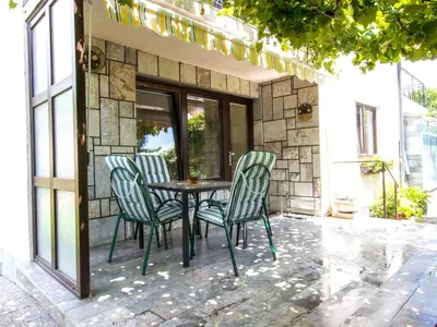 a table and four chairs on a patio at Apartments Julijana in Bled