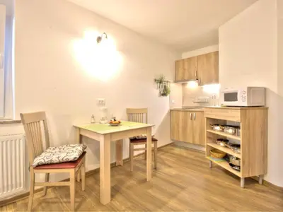 a kitchen with a table and chairs and a microwave at Apartments Julijana in Bled