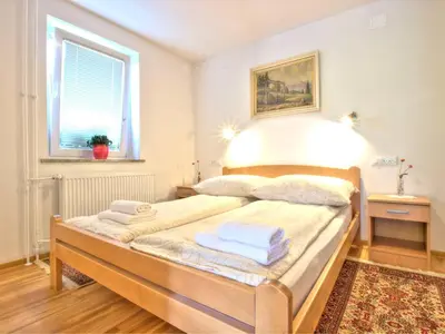 a bedroom with a bed with two towels on it at Apartments Julijana in Bled