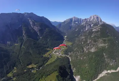 an aerial view of a mountain valley with a river at D-D in Bovec