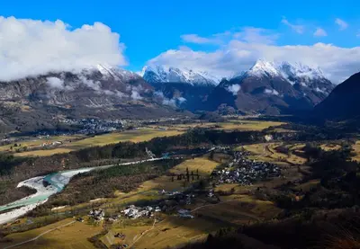 an aerial view of a valley with snow capped mountains at D-D in Bovec