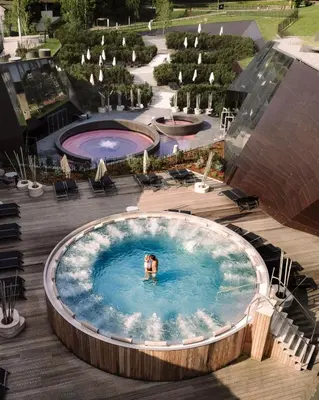 a person swimming in a large pool in a pool at Terme Olimia - Aparthotel Rosa in Podčetrtek