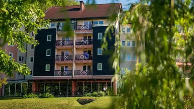 a view of the front of a building at Terme Olimia - Aparthotel Rosa in Podčetrtek