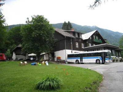 a bus parked in front of a building at Hostel pod Voglom in Bohinj