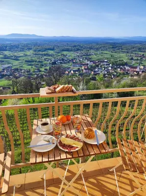 a table with plates of food on top of a balcony at Zidanica-Vineyard Cottage Jakše in Semič
