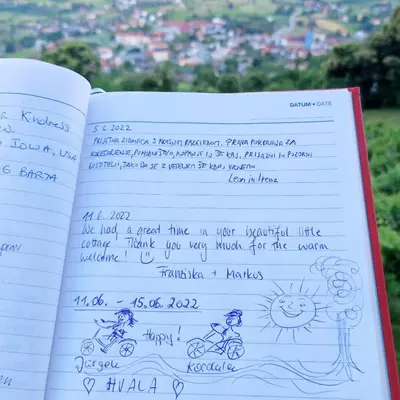 an open notebook with a drawing of a person riding a bike at Zidanica-Vineyard Cottage Jakše in Semič