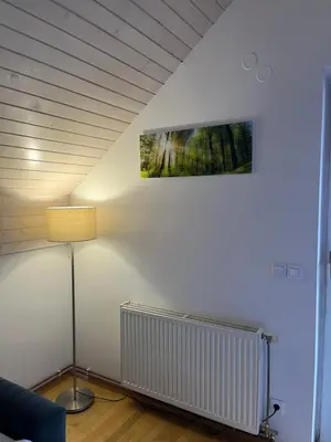 a room with a lamp and a picture on the wall at Apartment Story in Kranjska Gora