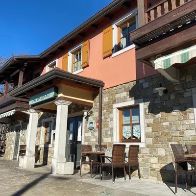 a table and chairs outside of a building at Domačija pri Damjanu in Kozina