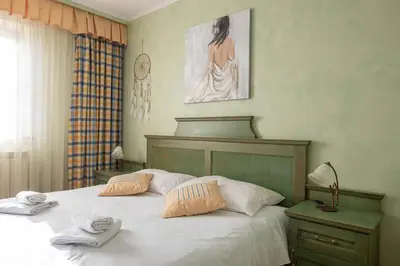 a bedroom with a bed with two towels on it at Domačija pri Damjanu in Kozina